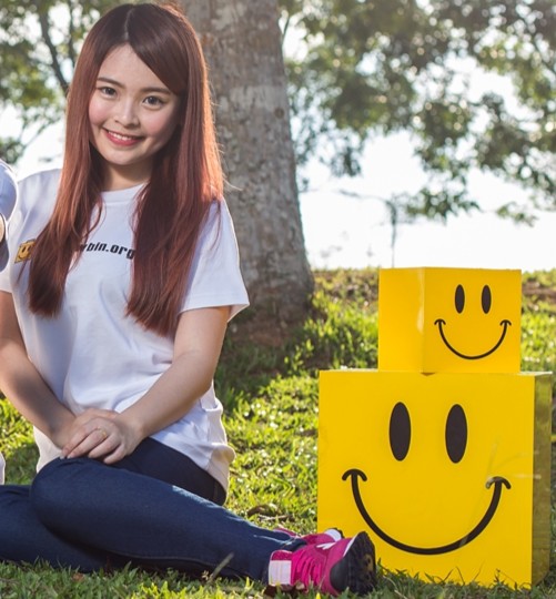 Yellow Bin volunteer with textile recycling boxes in Johor Bahru, recycle clothes initiative
